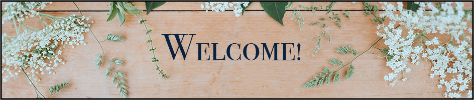 A rectangular wooden background with flowers surrounding the edges. Text saying welcome displayed in the center.